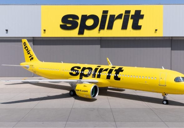 Spirit Airlines Airbus A321neo in front of a hangar